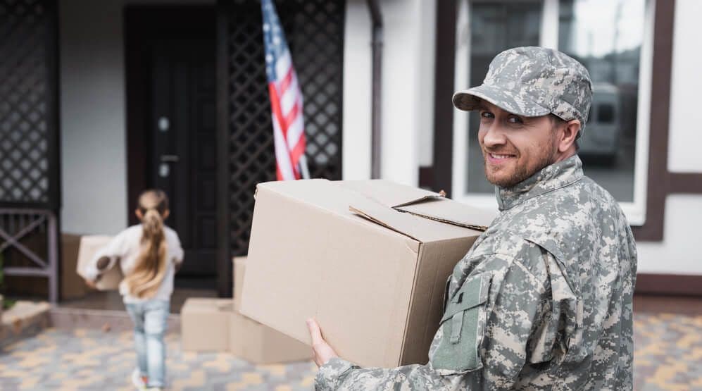 military man moving storage box