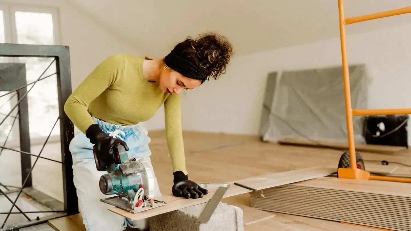 woman cutting wood in home