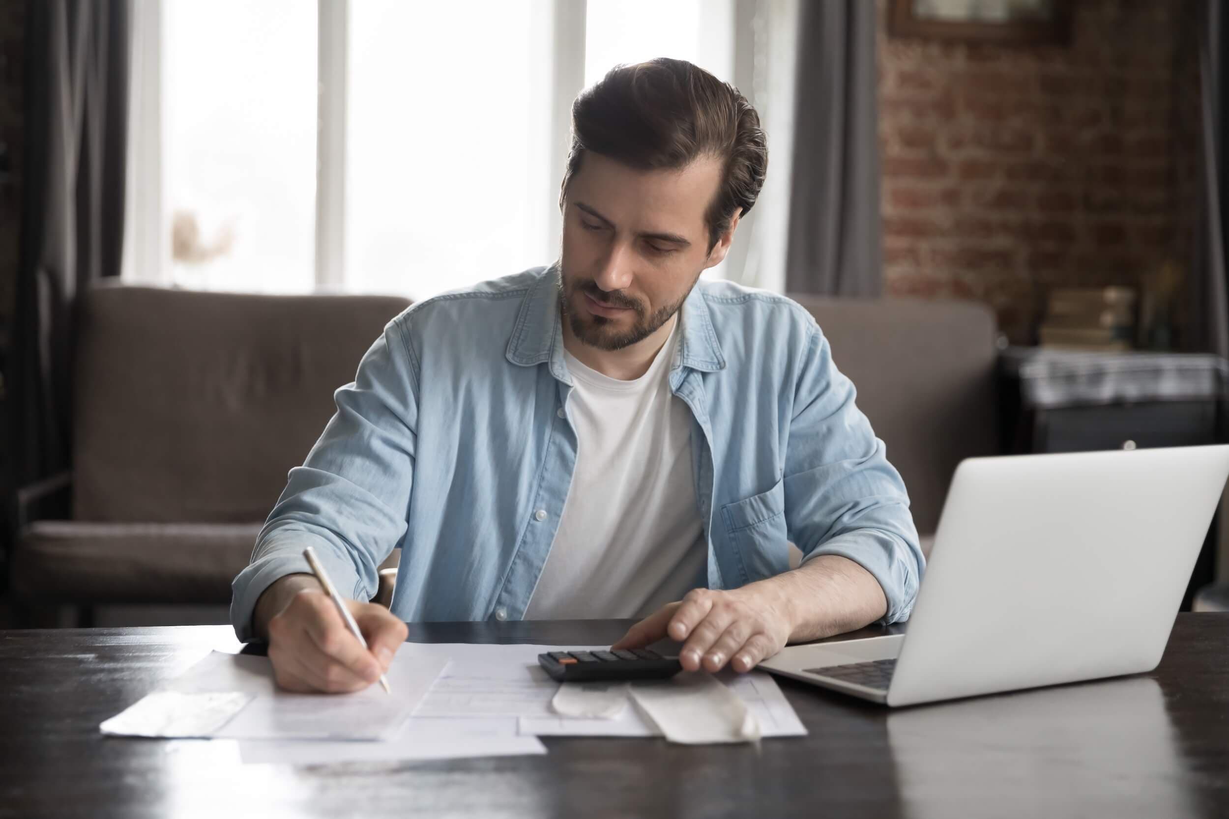 man doing taxes at table